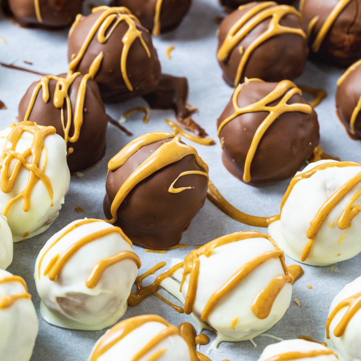 White chocolate and Milk Chocolate covered truffles drizzled with peanut butter.