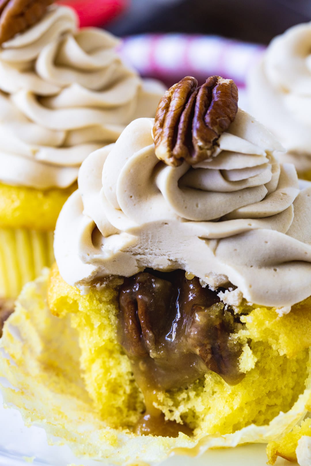 Pecan Pie Cupcakes with a bite taken out to show inside.