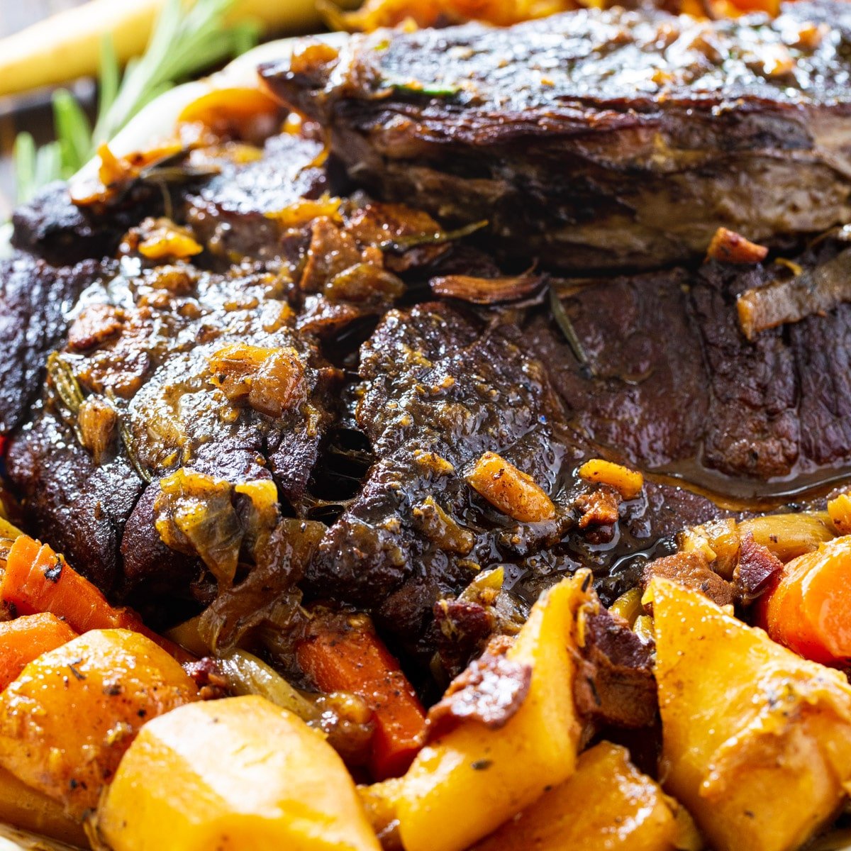 Close-up of Pot Roast surrounded by vegetables.