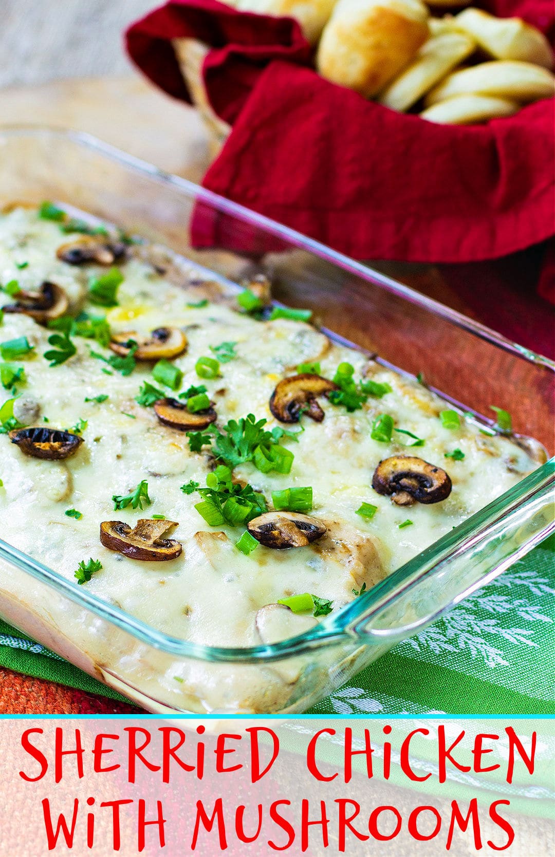 Chicken with Mushrooms in a casserole dish with basket of rolls in background.