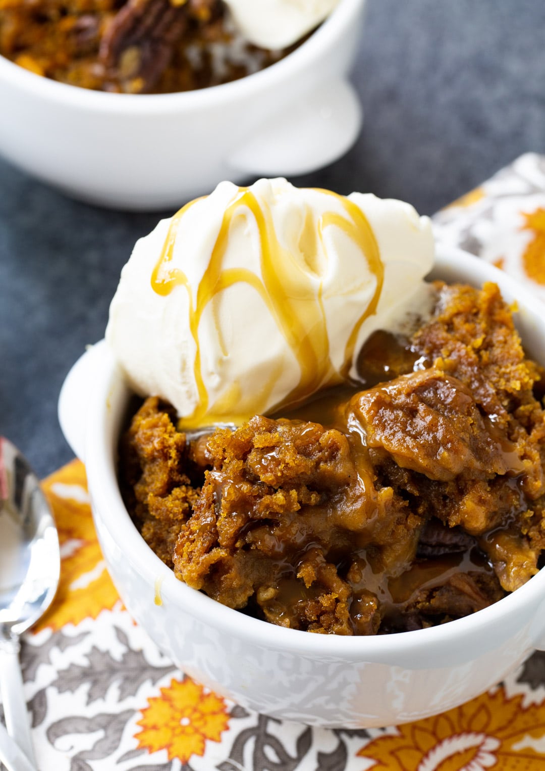 Slow Cooker Pumpkin Cake topped with ice cream in a bowl.