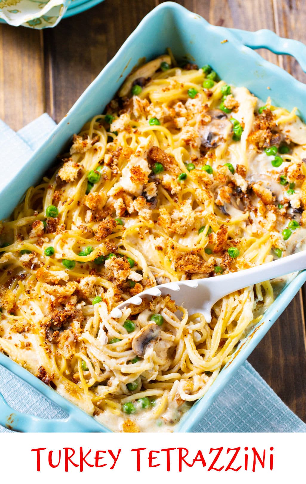 Cooked casserole in a blue casserole dish.