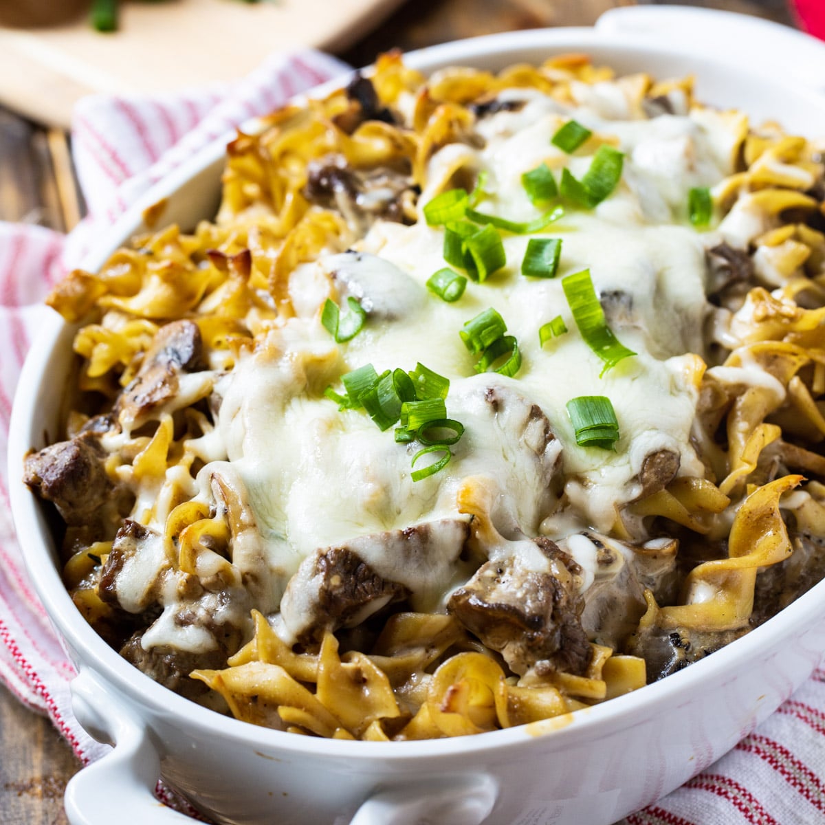 Beef Stroganoff Casserole covered with melted cheese in a casserole dish.