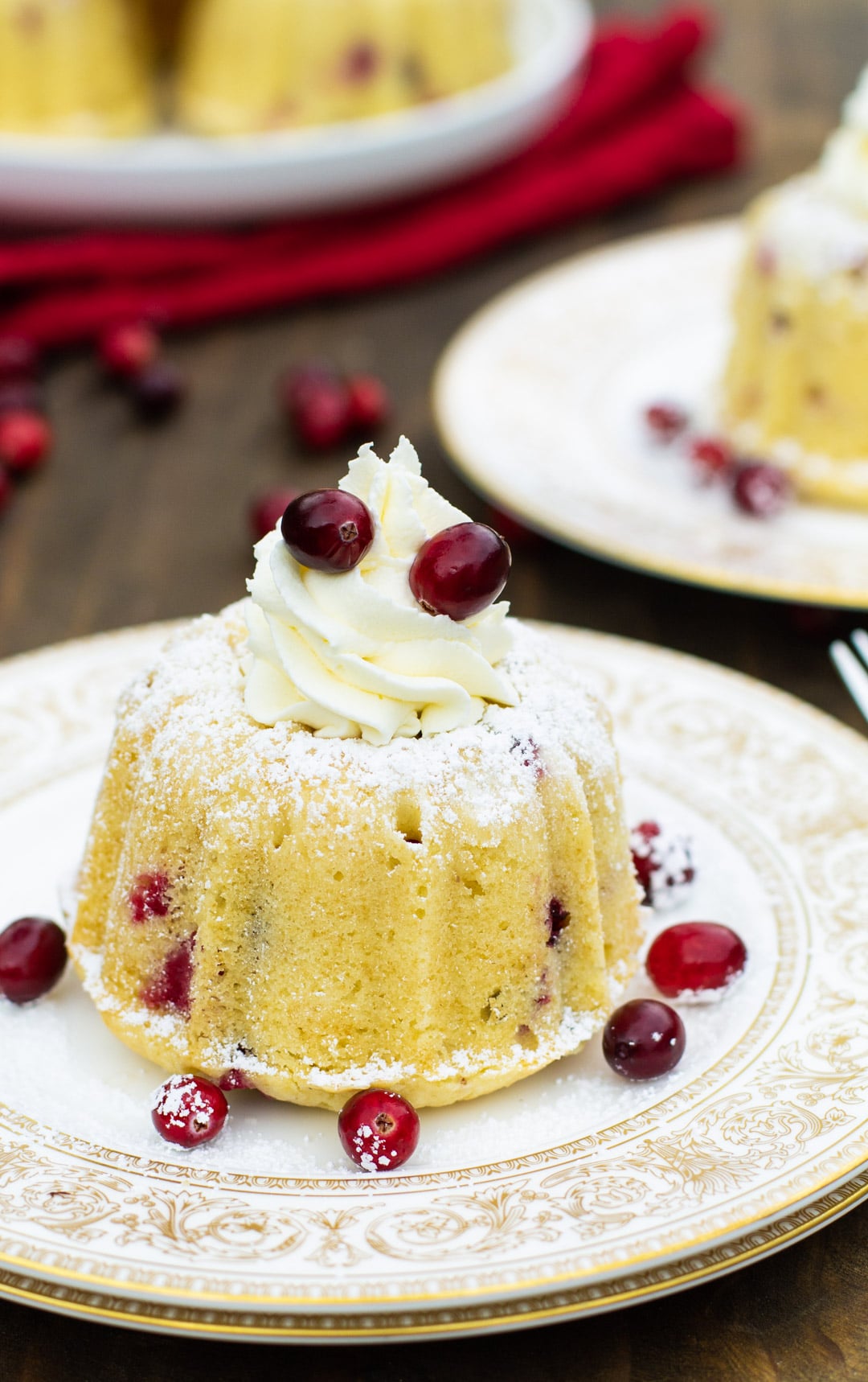 Almond Cranberry Cake with Mascarpone Frosting on gold-plated plate.