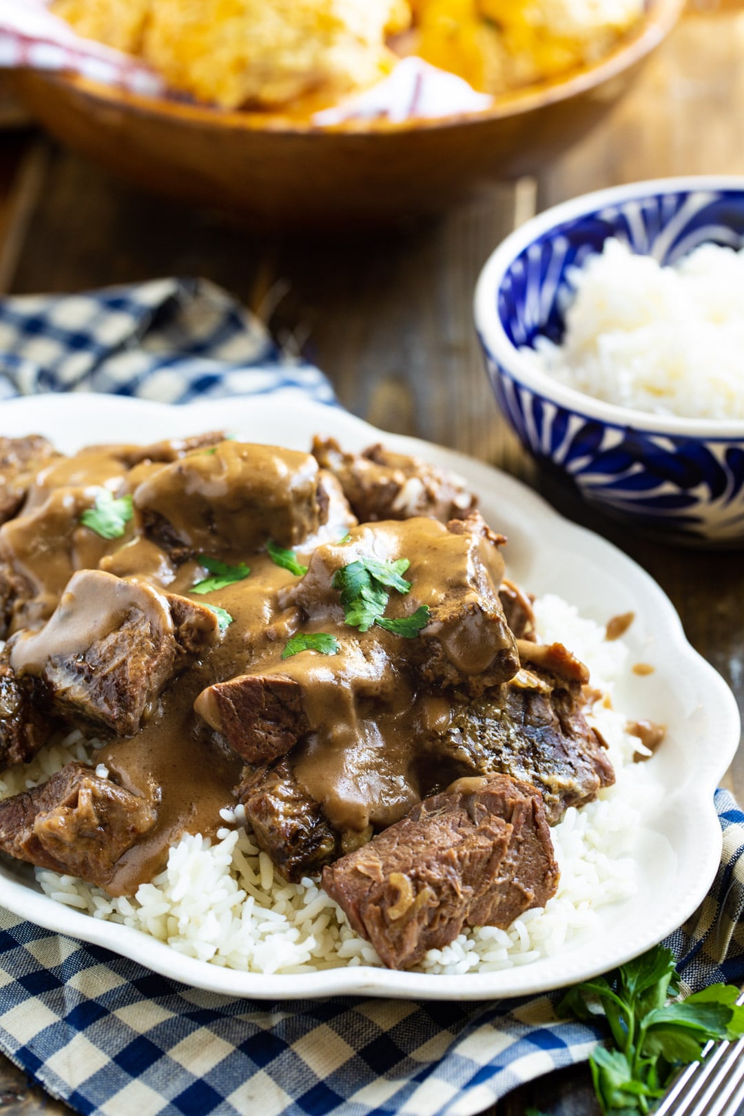 Beef Tips on a serving platter and bowl full of rice.