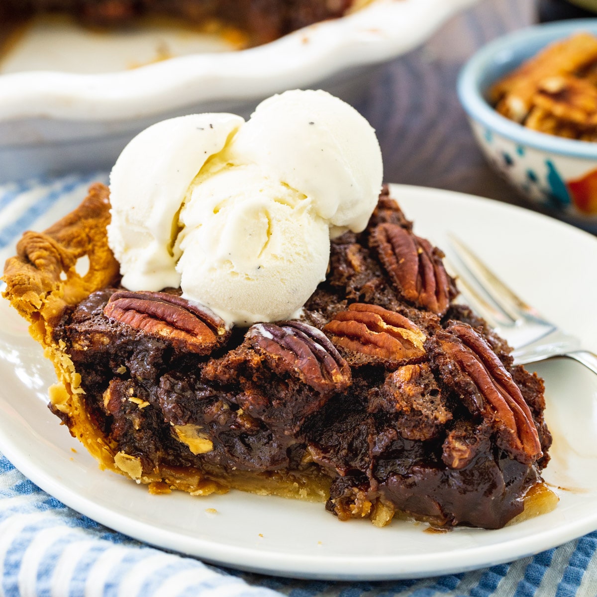 Mocha Pecan Pie slice topped with whipped cream.