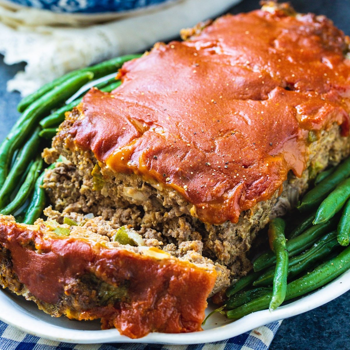 Old-School Meatloaf on serving platter with green beans.