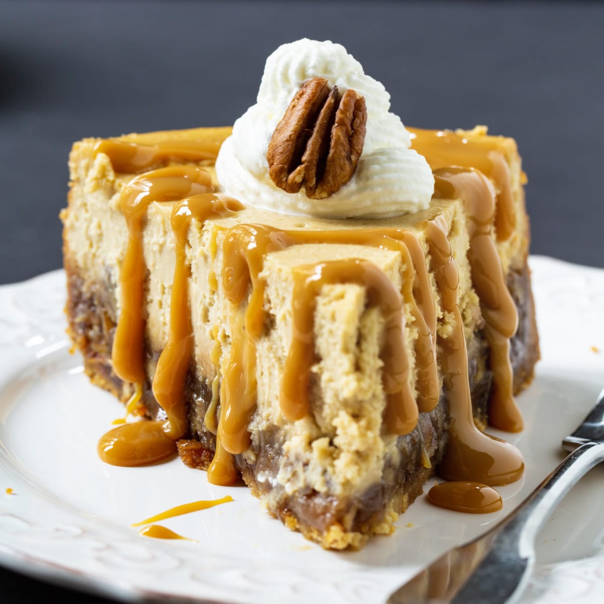 Pecan Pie Cheesecake slice drizzled with Dulce de Leche.