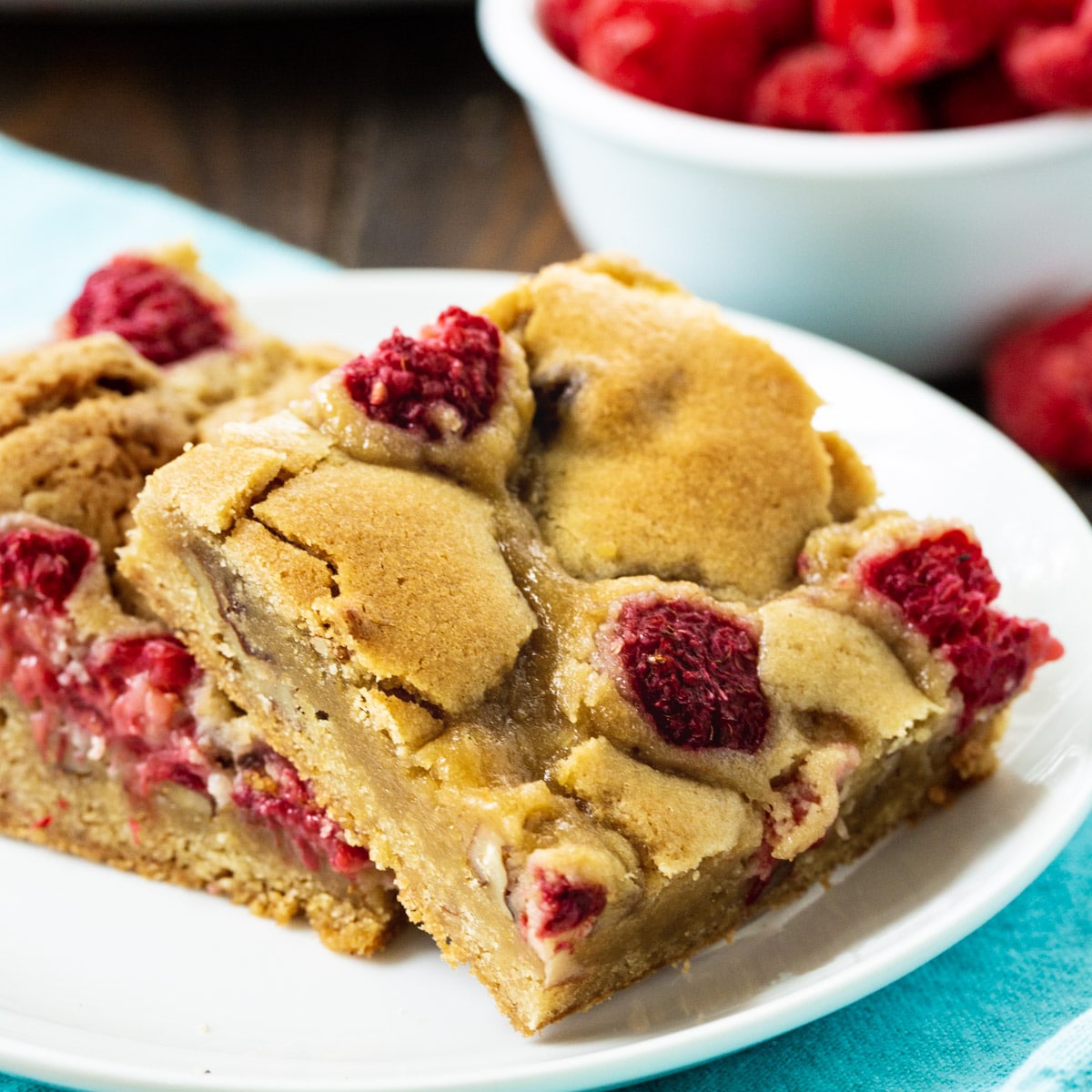 Two Raspberry Pecan Blondies on a plate.