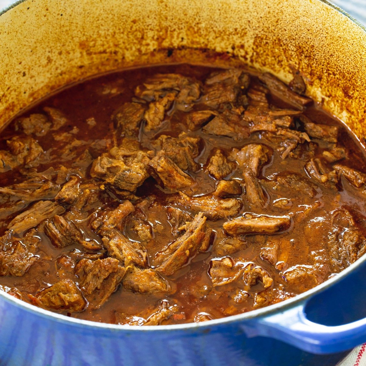 Sweet and Tangy Barbecue Beef in a Dutch oven.
