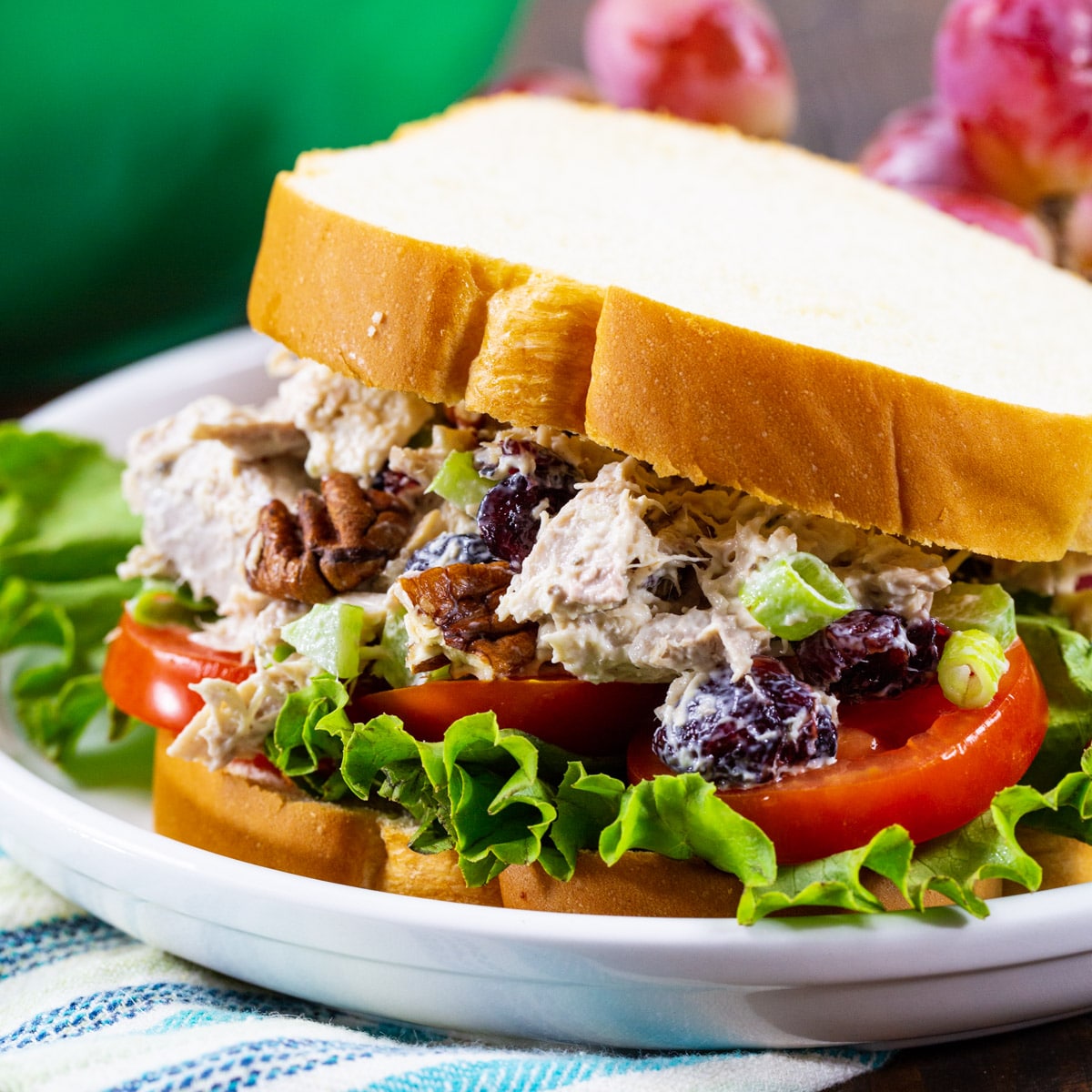 Turkey Salad in a sandwich with lettuce and tomato.