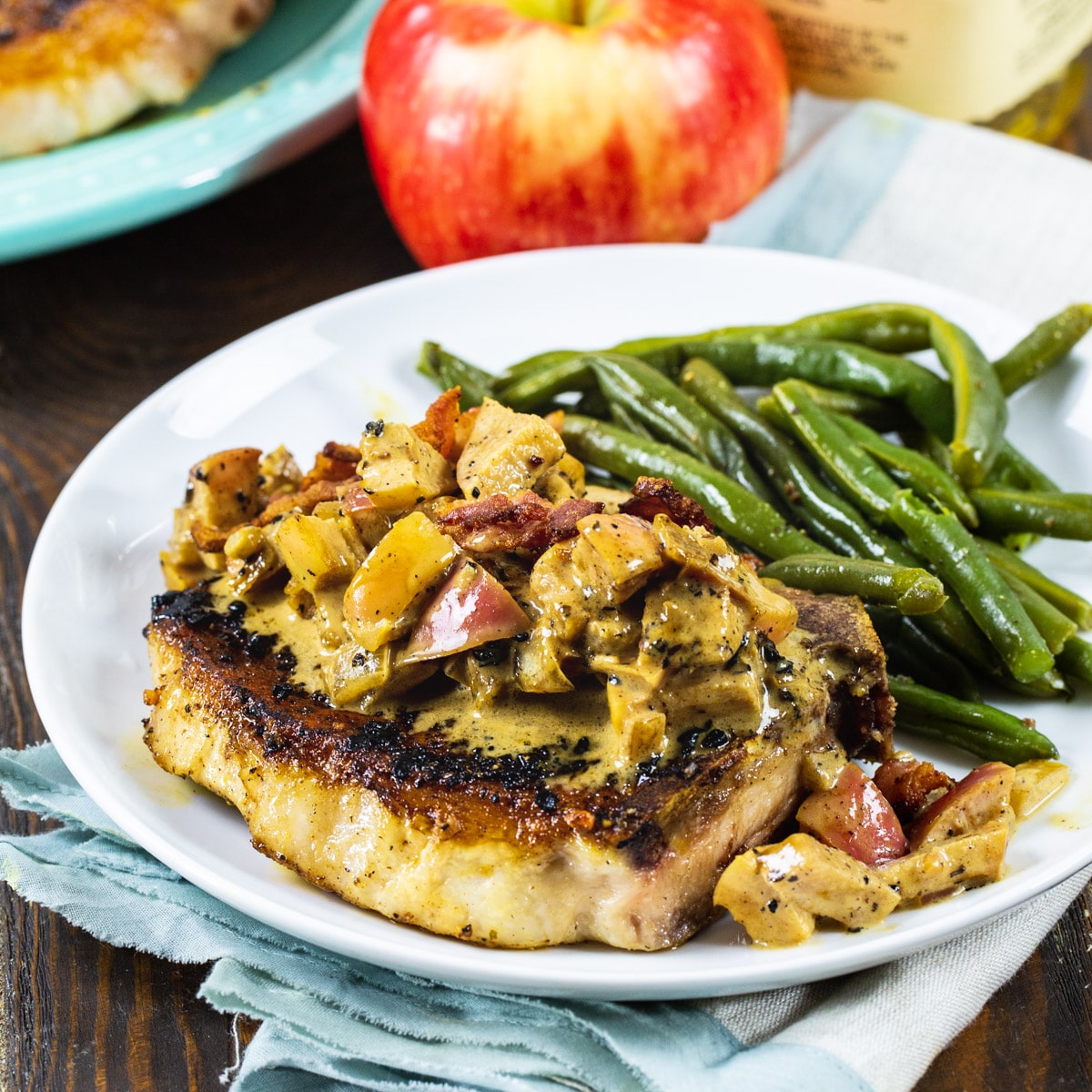 Bourbon Apple Pork Chops on plate with green beans.