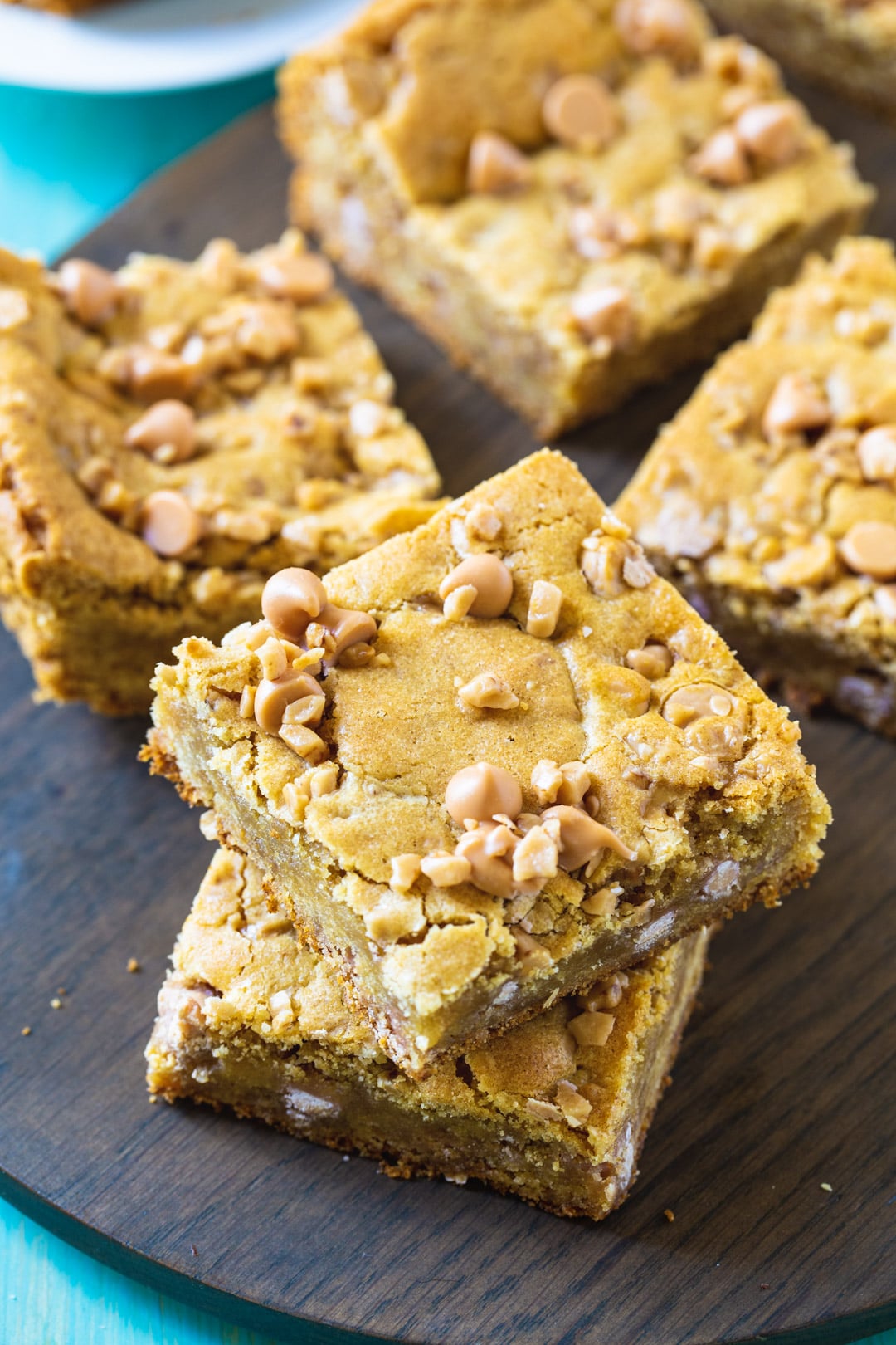 Blondies cut in squares on a wood cutting board.