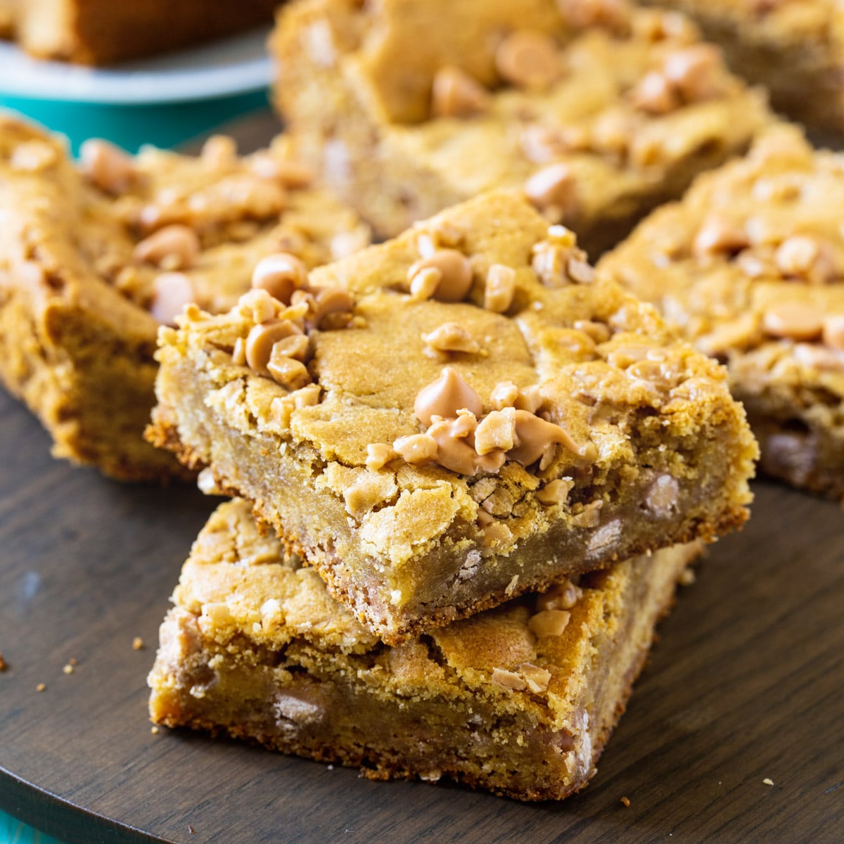 Butterscotch Toffee Blondies arranged on a wood cutting board.