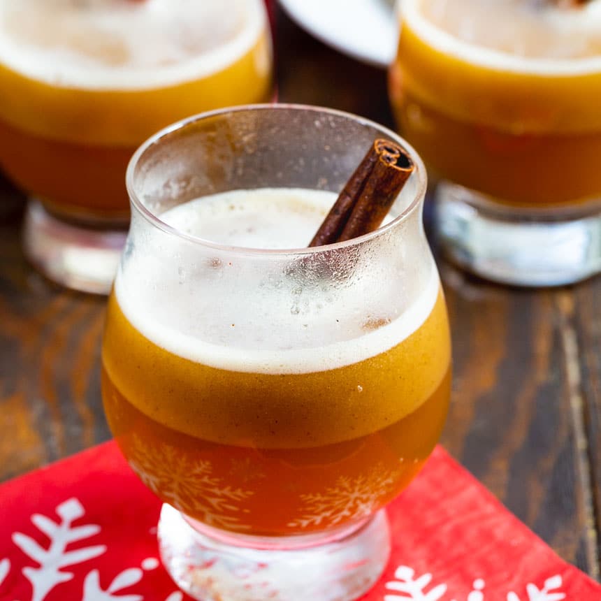 Hot Buttered Bourbon in a glass with a cinnamon stick.