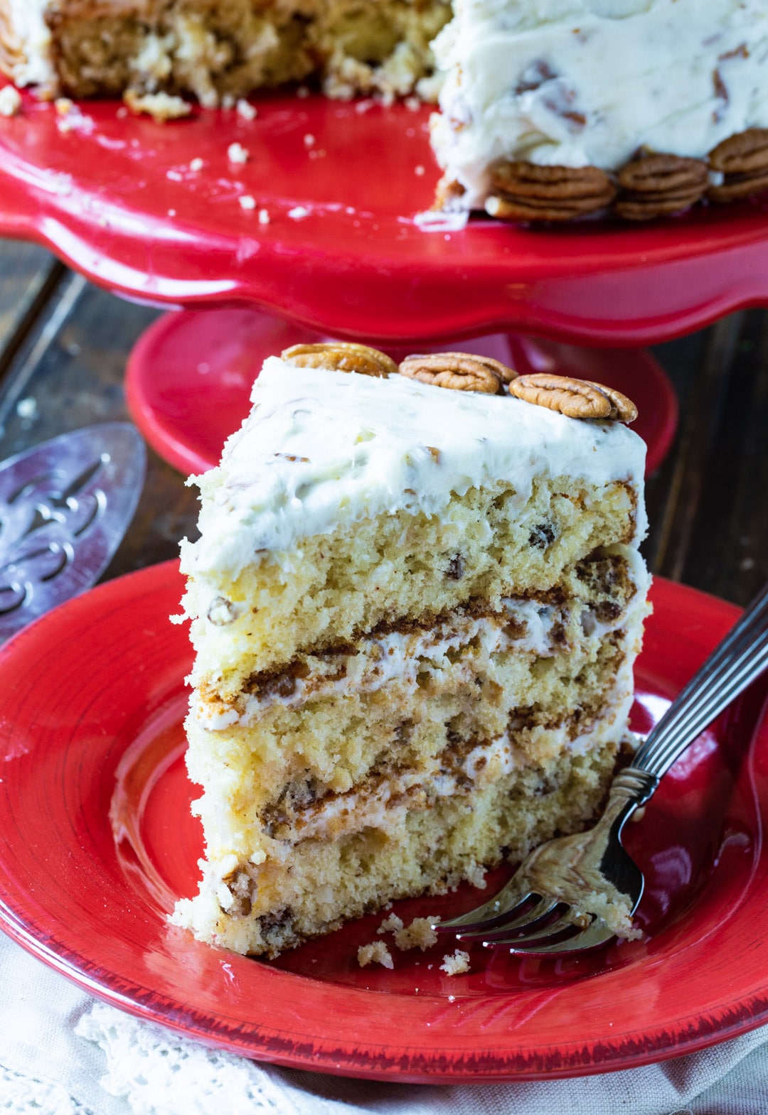 Slice of Italian Cream Cake on a red plate.