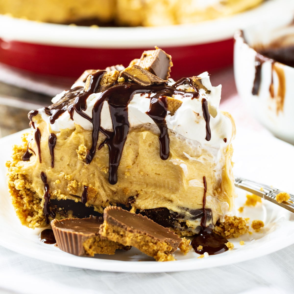 Slice of Peanut Butter Pie on a plate with peanut butter cups.