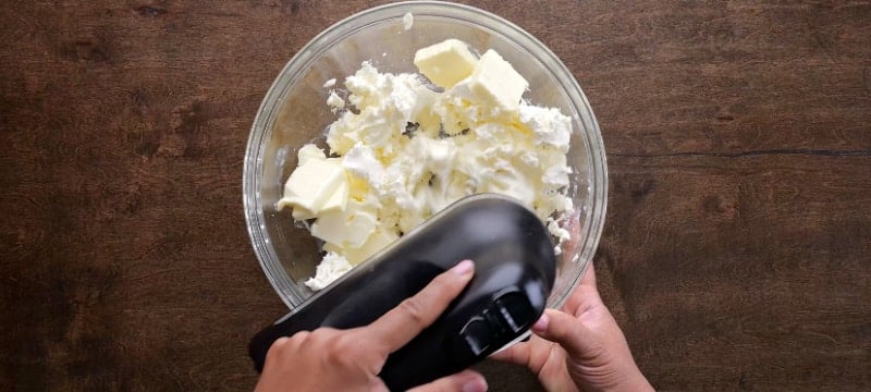 Creaming butter and cream cheese.