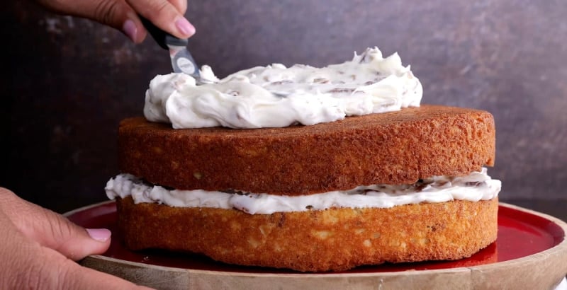 Spreading the frosting.