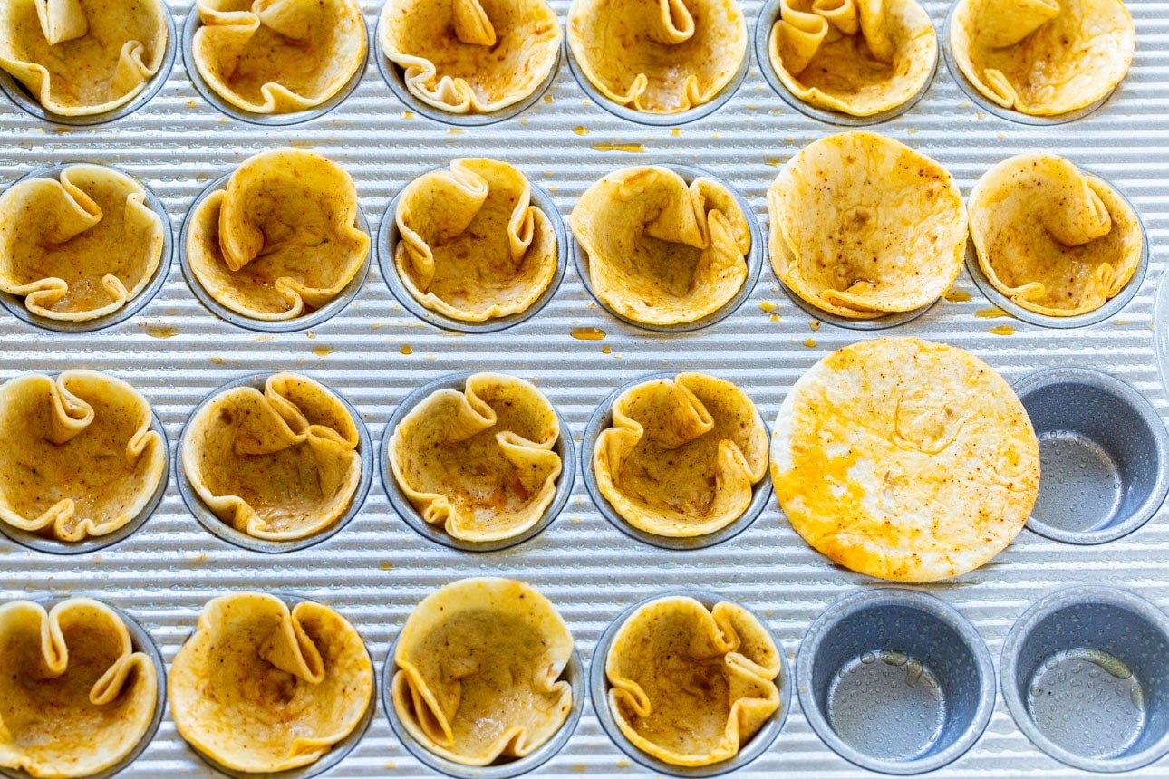 Press tortilla circles into muffin tin.