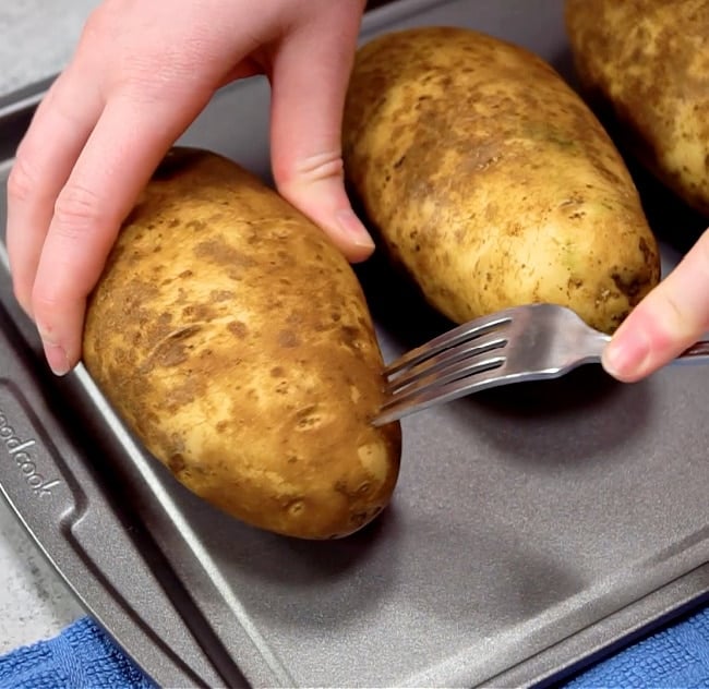 Piercing the potatoes.
