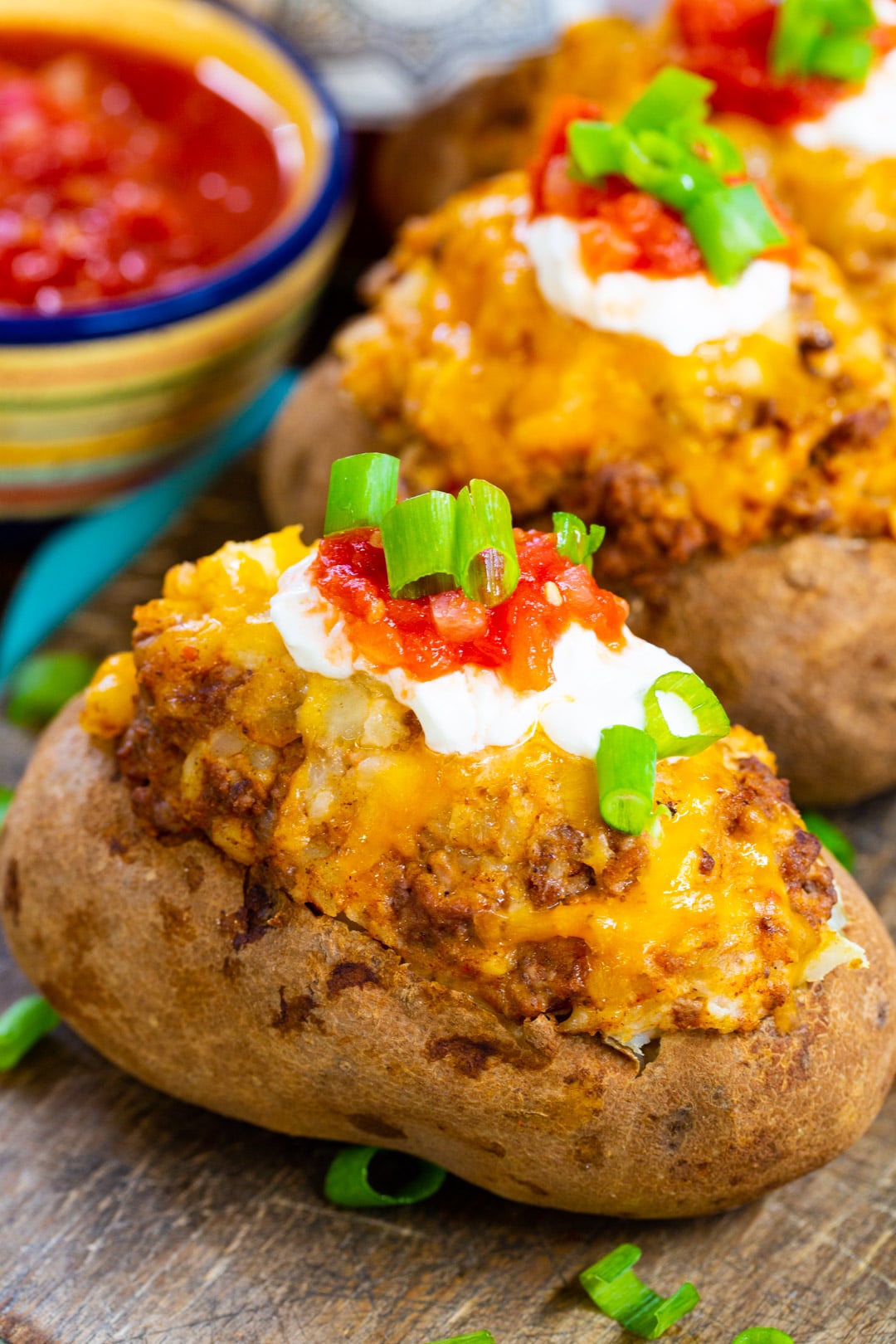 Stuffed Potatoes topped with sour cream and salsa.