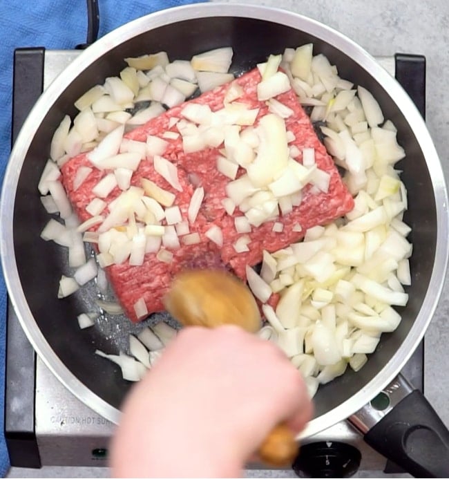 Cooking ground beef and onion.