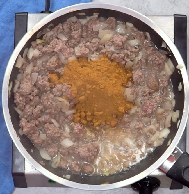 Adding taco seasoning.