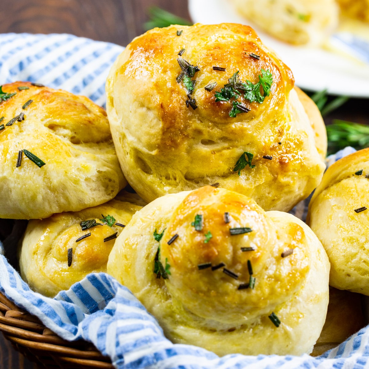Buttery Herb Yeast Rolls in a basket.