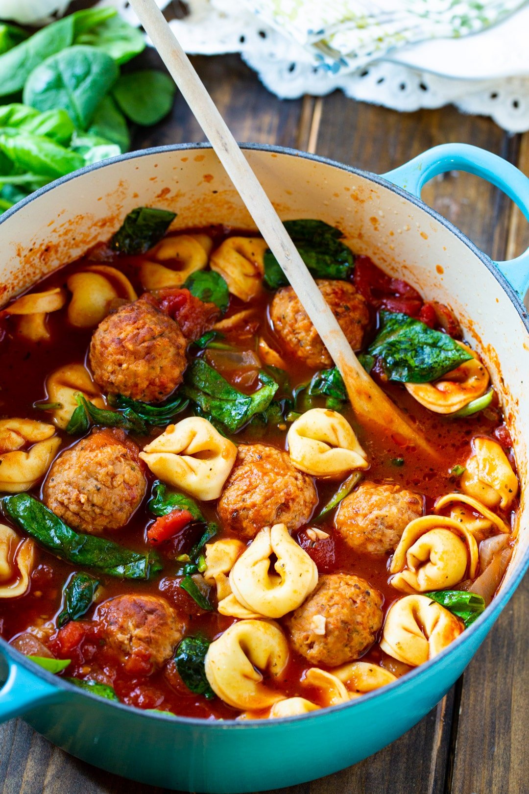 Soup in a Dutch oven with wooden spoon.