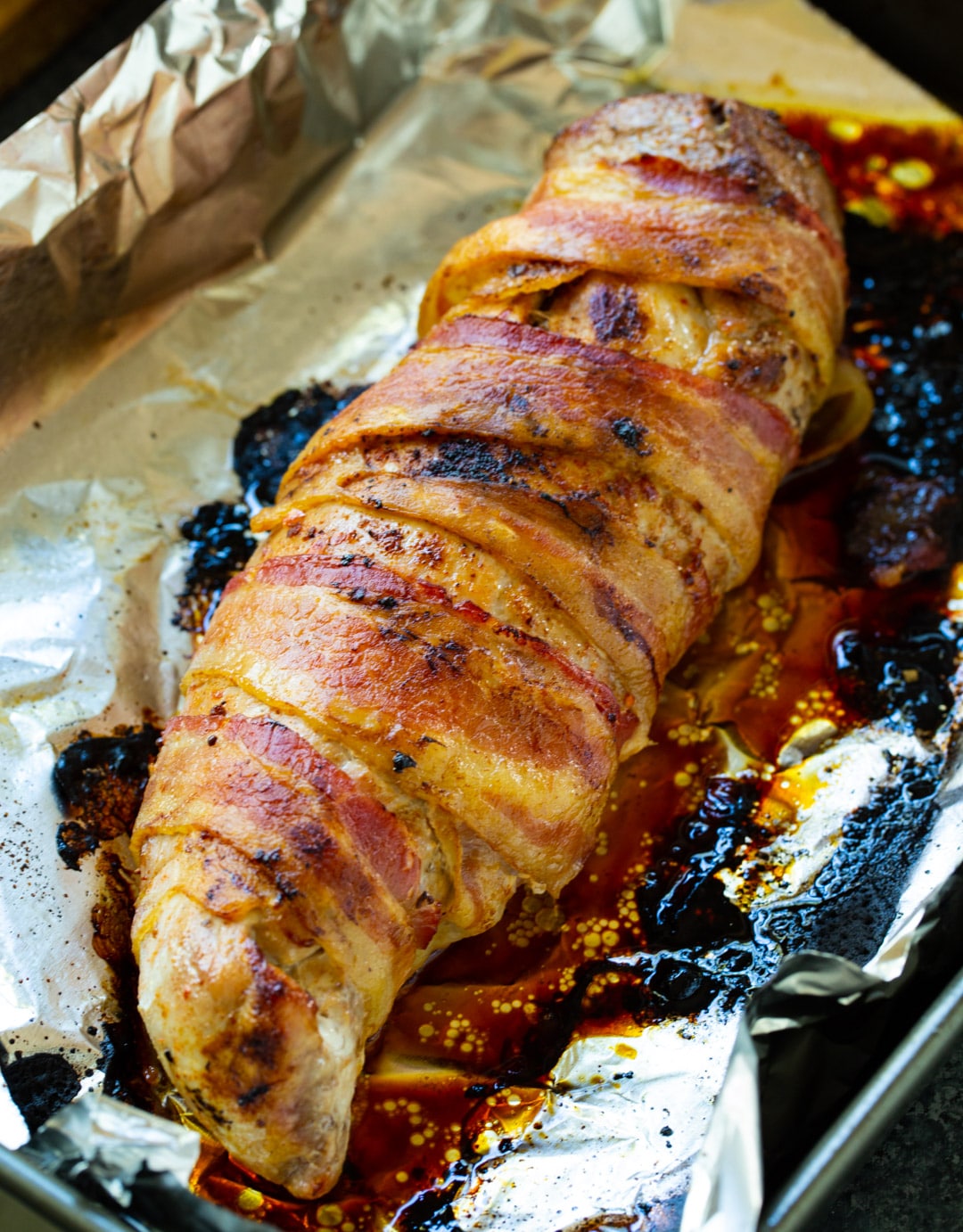 Cooked pork tenderloin on baking sheet.