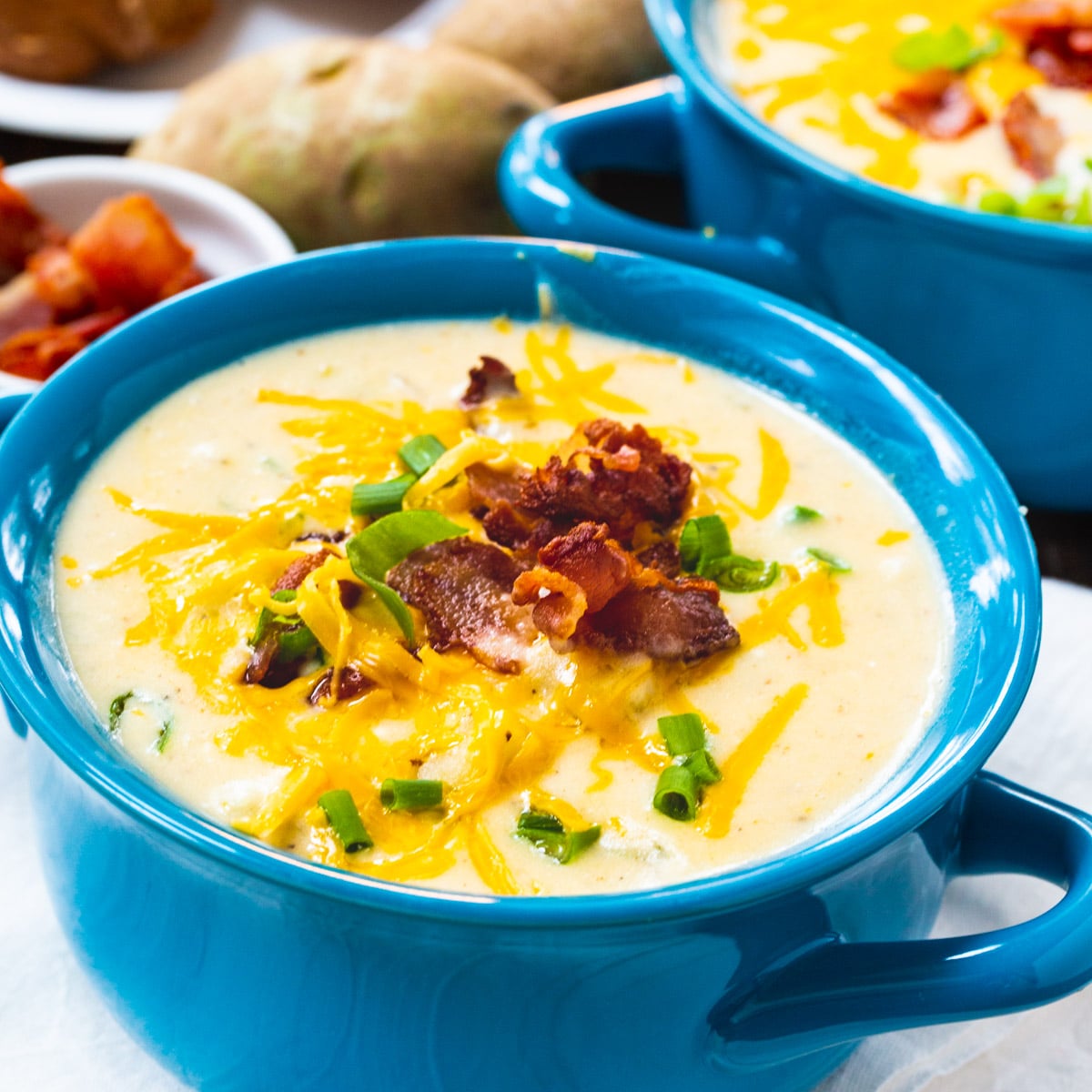 Baked Potato Soup in a blue bowl.