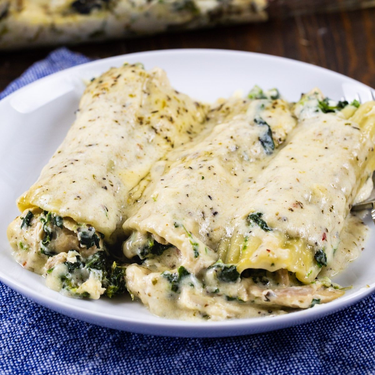 Two Chicken Florentine Manicotti on a plate.