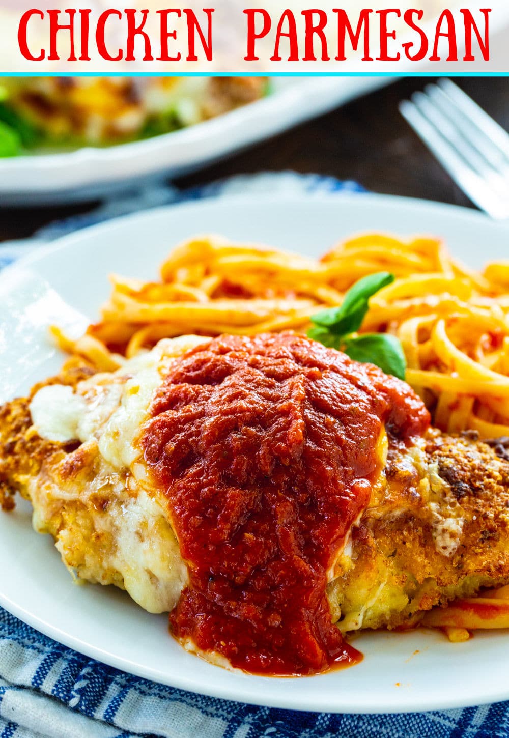 Chicken Parmesan on a plate with pasta.