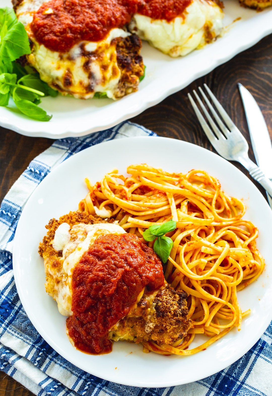 Chicken Parmesan on plate with pasta.