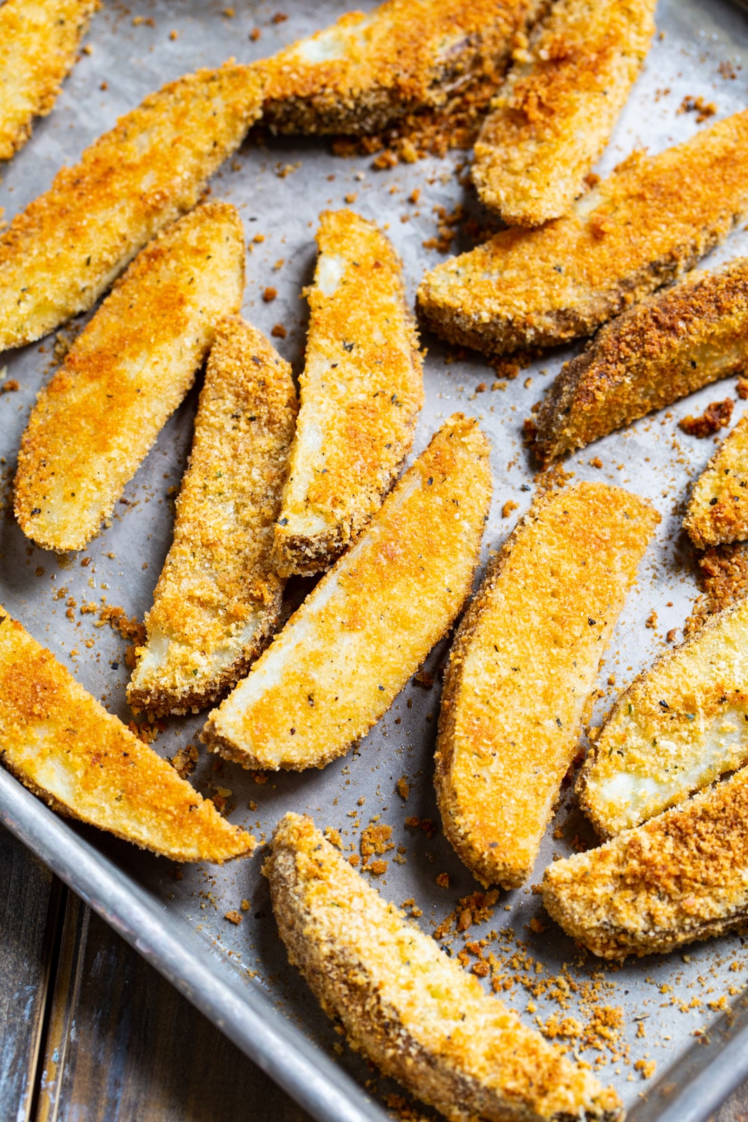 Cooked potato wedges on a baking sheet.