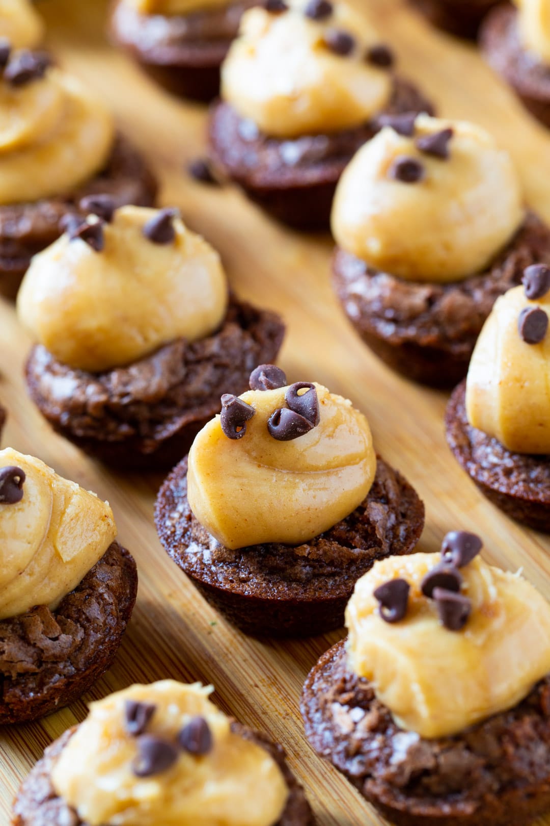 Peanut Butter Brownie Bites arranged on a wood board.