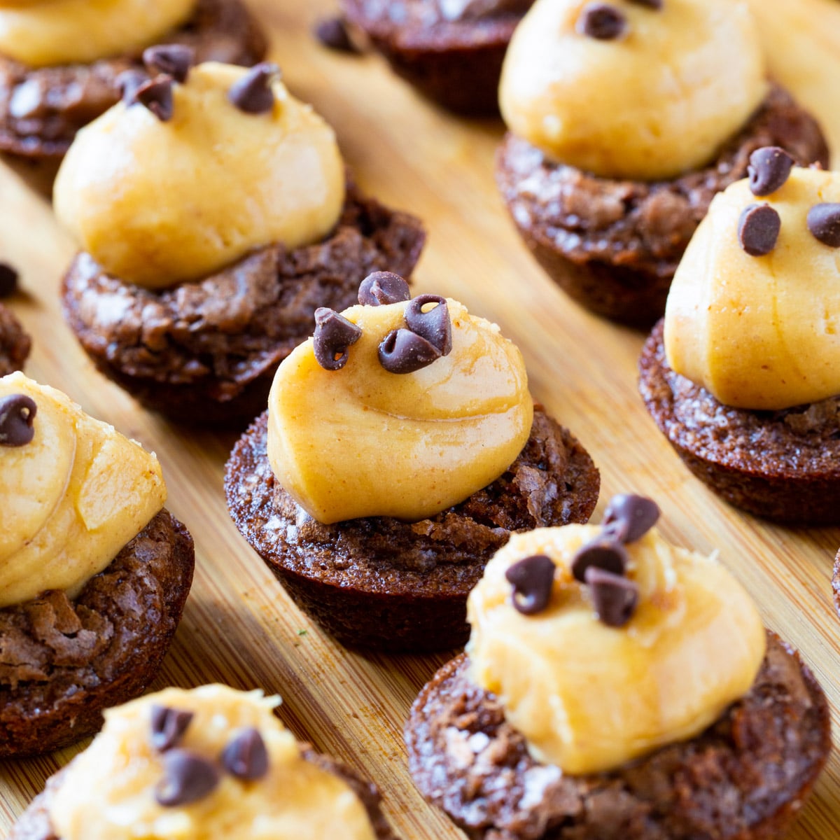 Peanut Butter Brownie Bites arranged on a wood board.