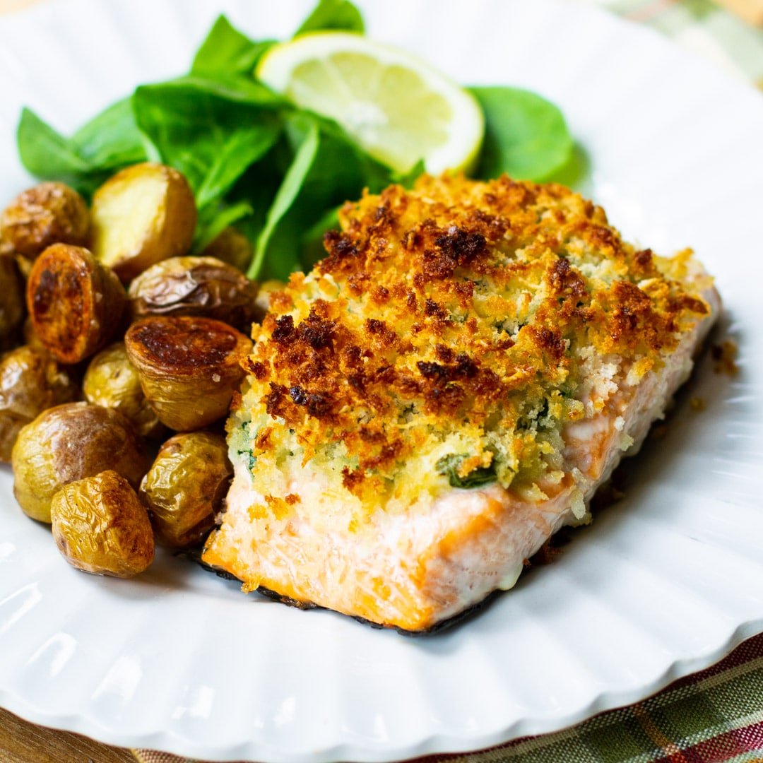Baked Salmon Stuffed with Mascarpone Spinach on a plate with roasted potatoes.
