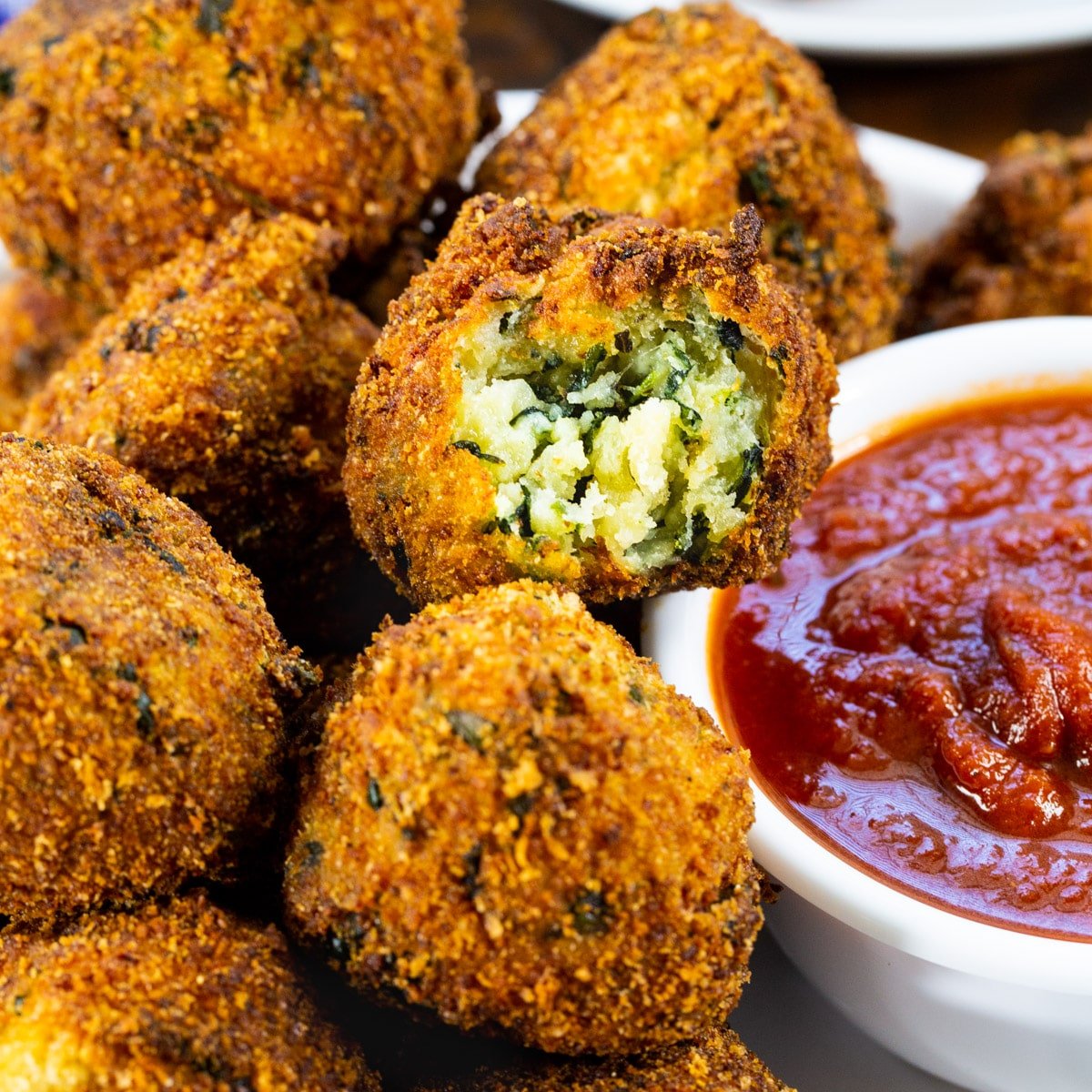 Spinach Cheese Balls with a bowl of pizza sauce.