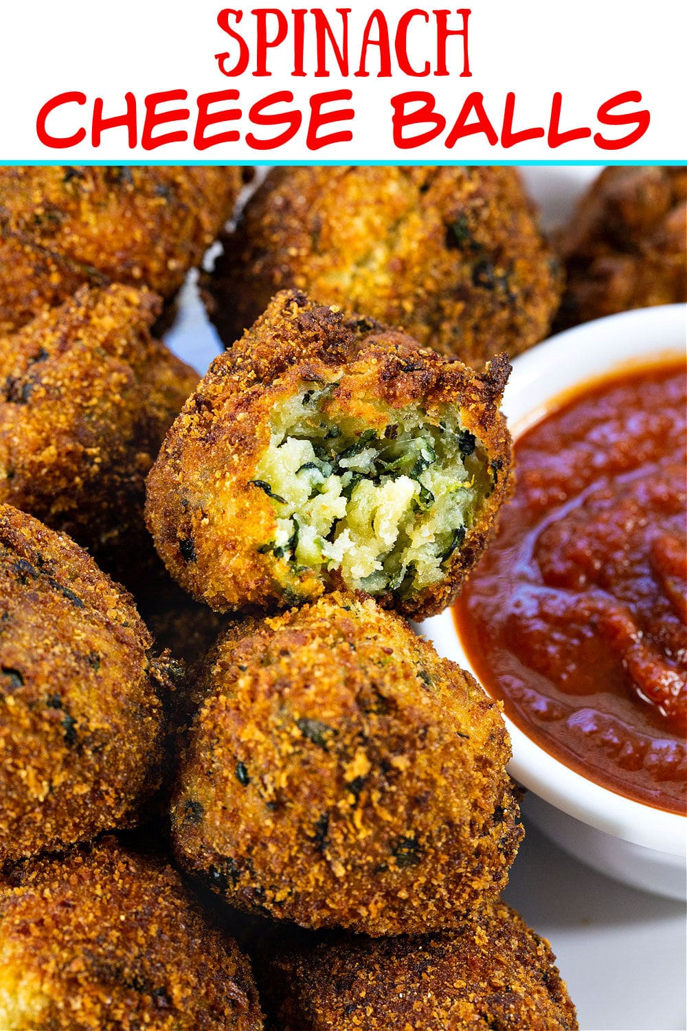 Spinach Cheese Balls with bite taken out of one to show inside.