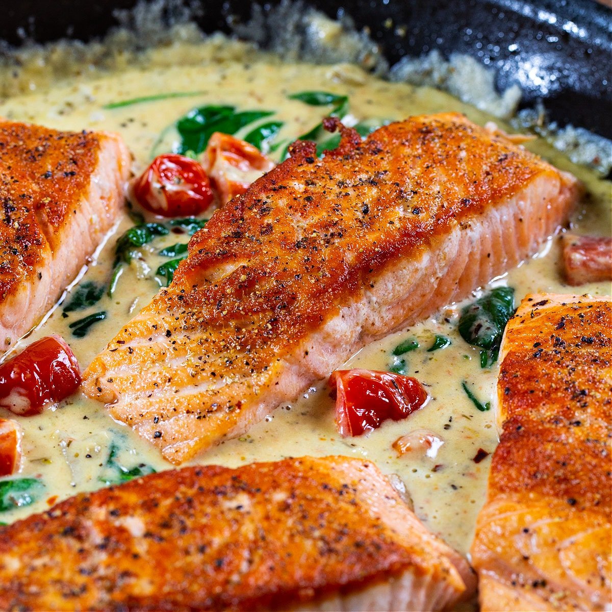 Creamy Tuscan Salmon in a skillet.