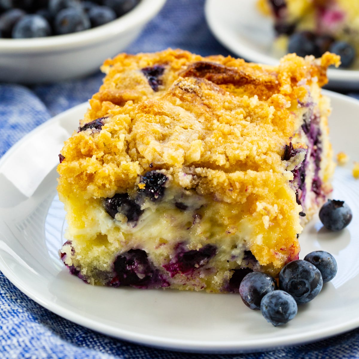 Slice of Blueberry Cream Cheese Coffee Cake on a plate.