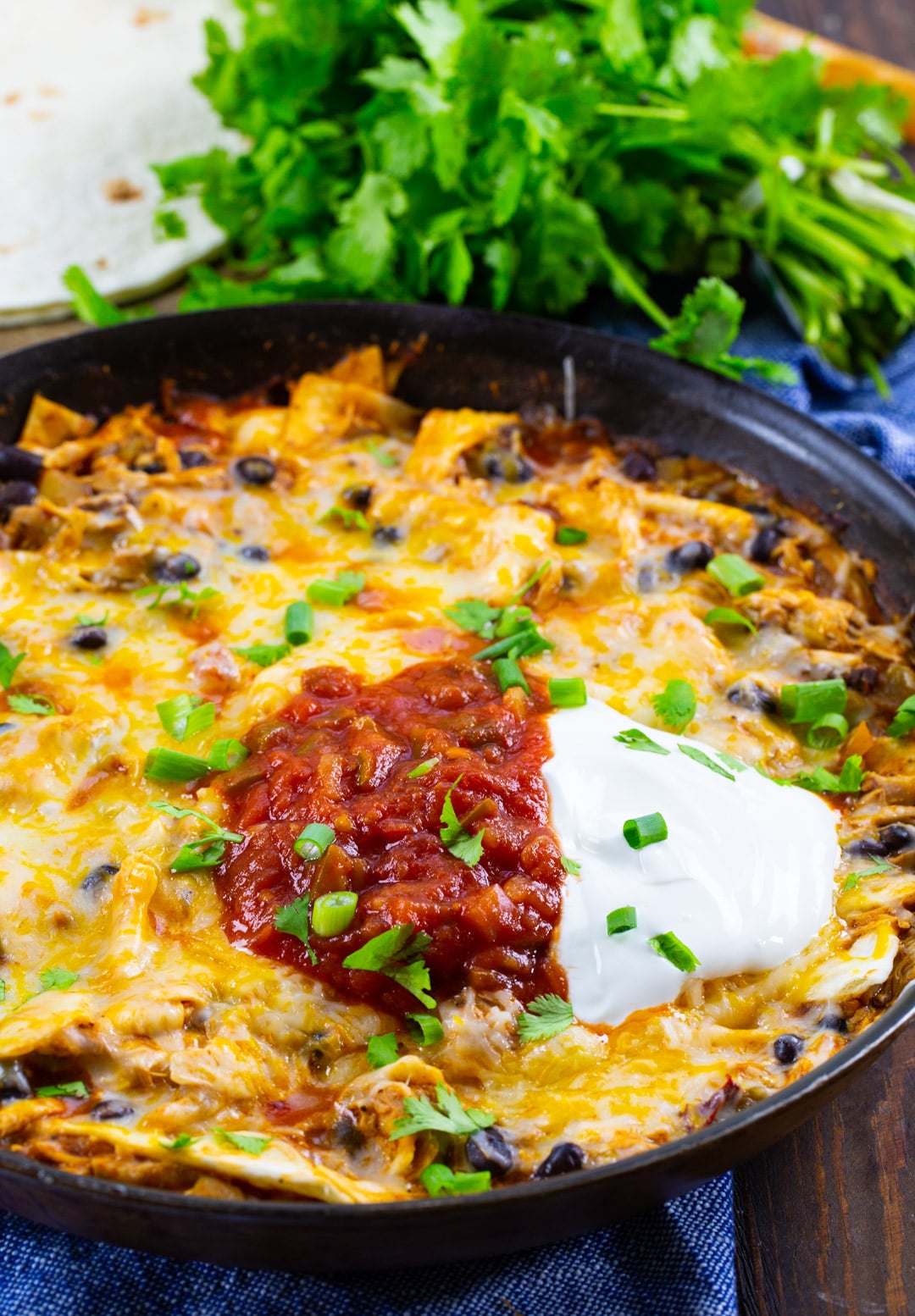 Chipotle Chicken Enchilada Skillet topped with sour cream and salsa.