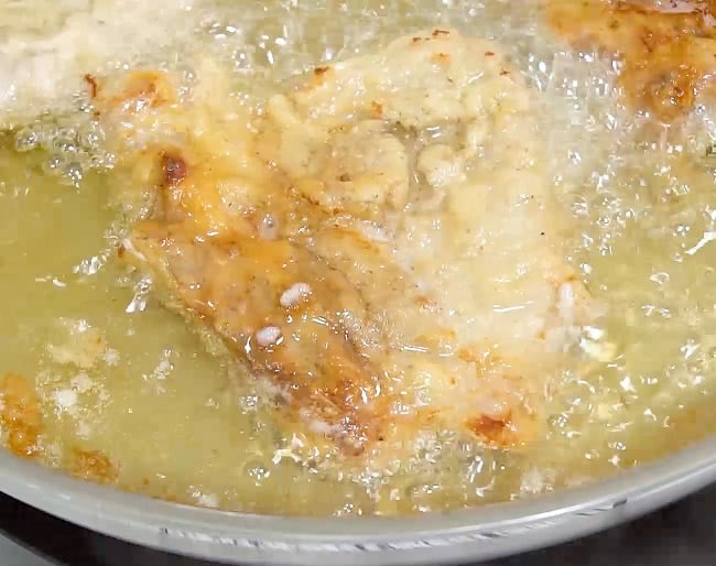 Frying the pork chops.