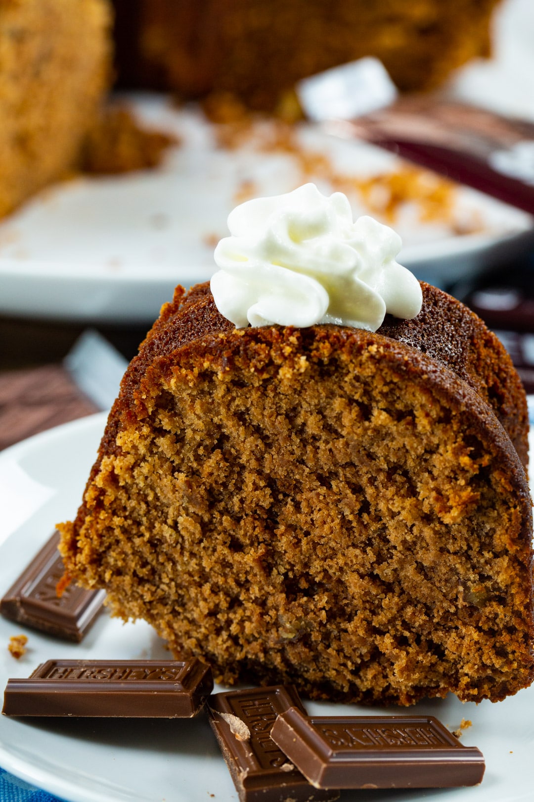 Slice of cake topped with whipped cream.