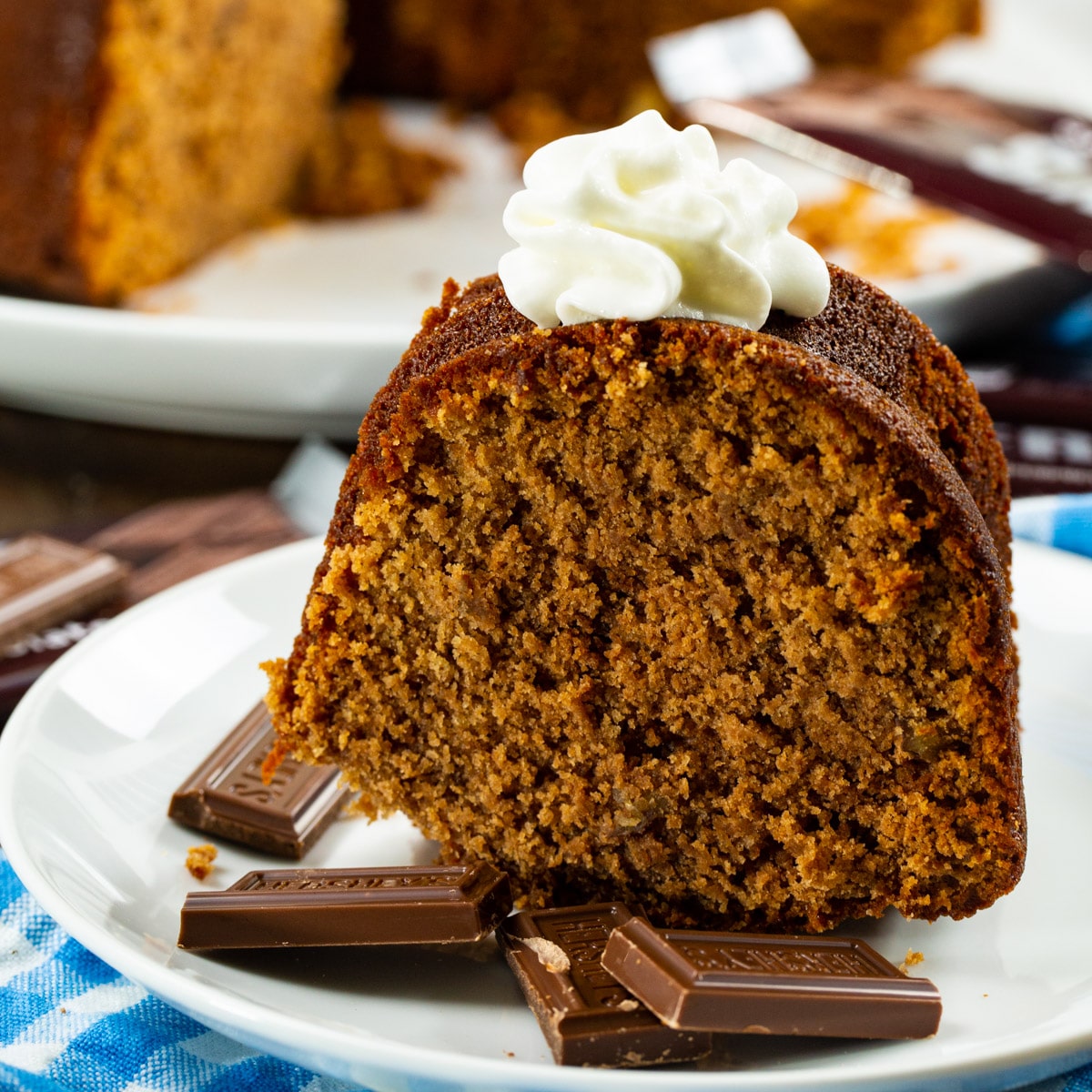 Hershey Bar Pound Cake slice on a plate with squares of hershey bar.