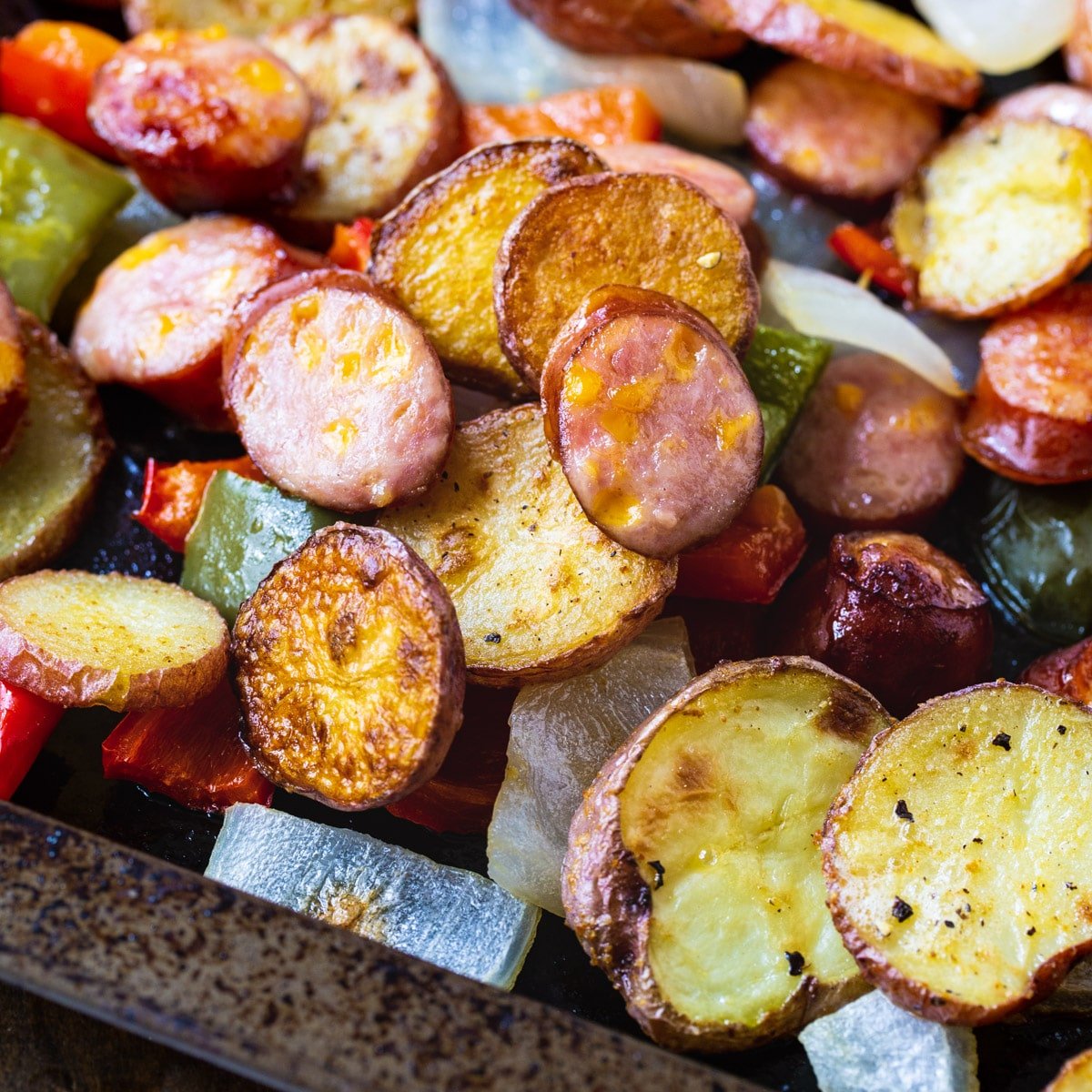 Oven-Roasted Sausage and Potatoes on a baking sheet.