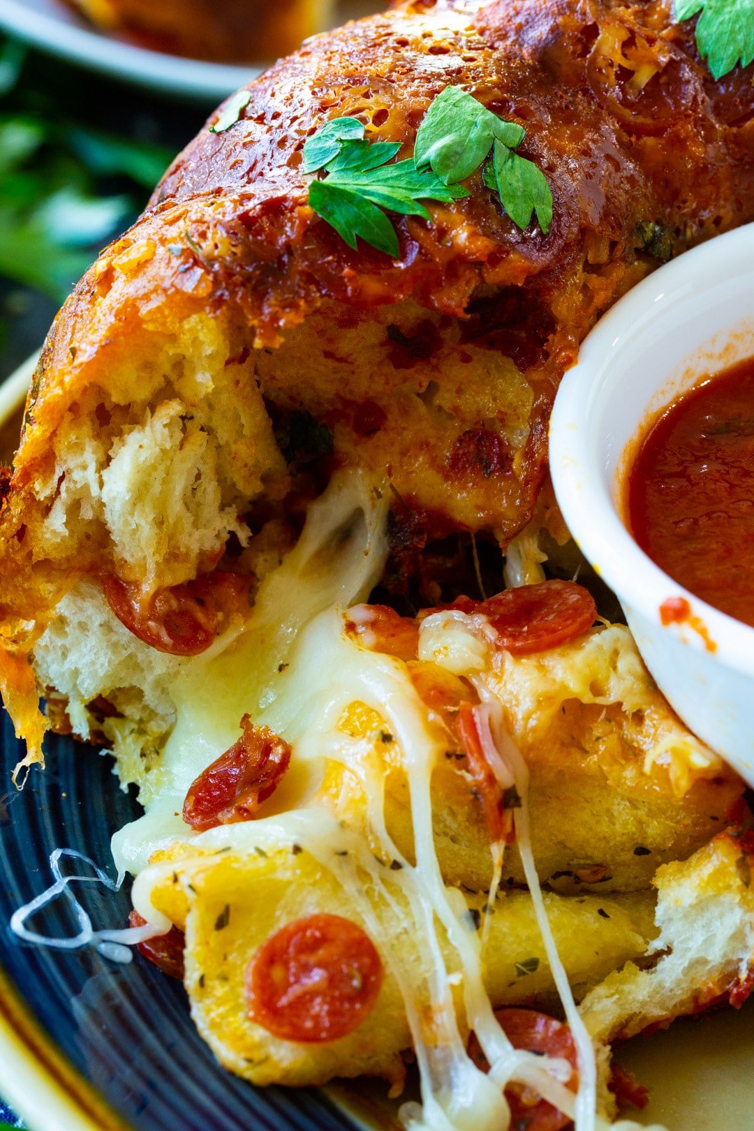 Pizza Monkey Bread with mini pepperonis on a plate.