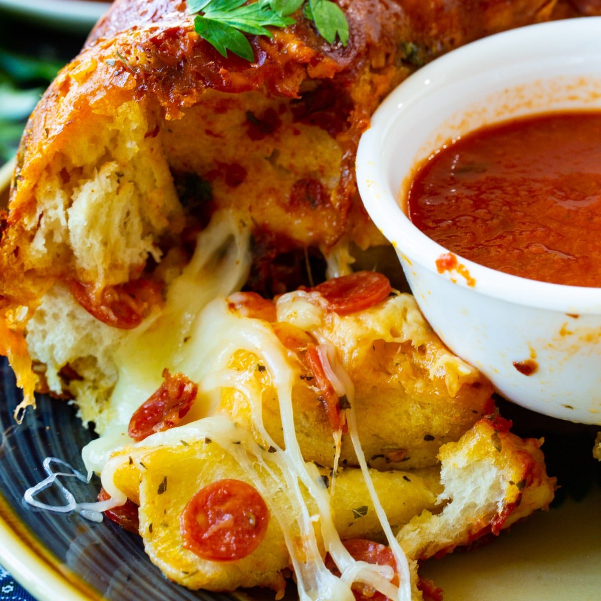 Pizza Monkey Bread on plate with bowl of marinara.